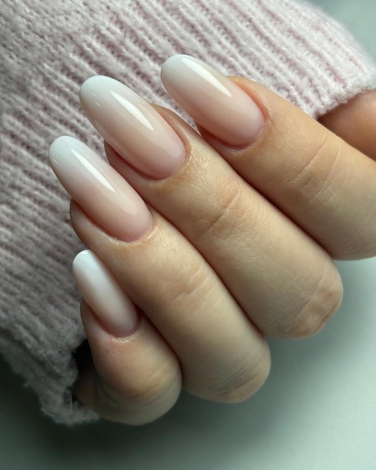 Manicure con smalto nude perlato su unghie a mandorla